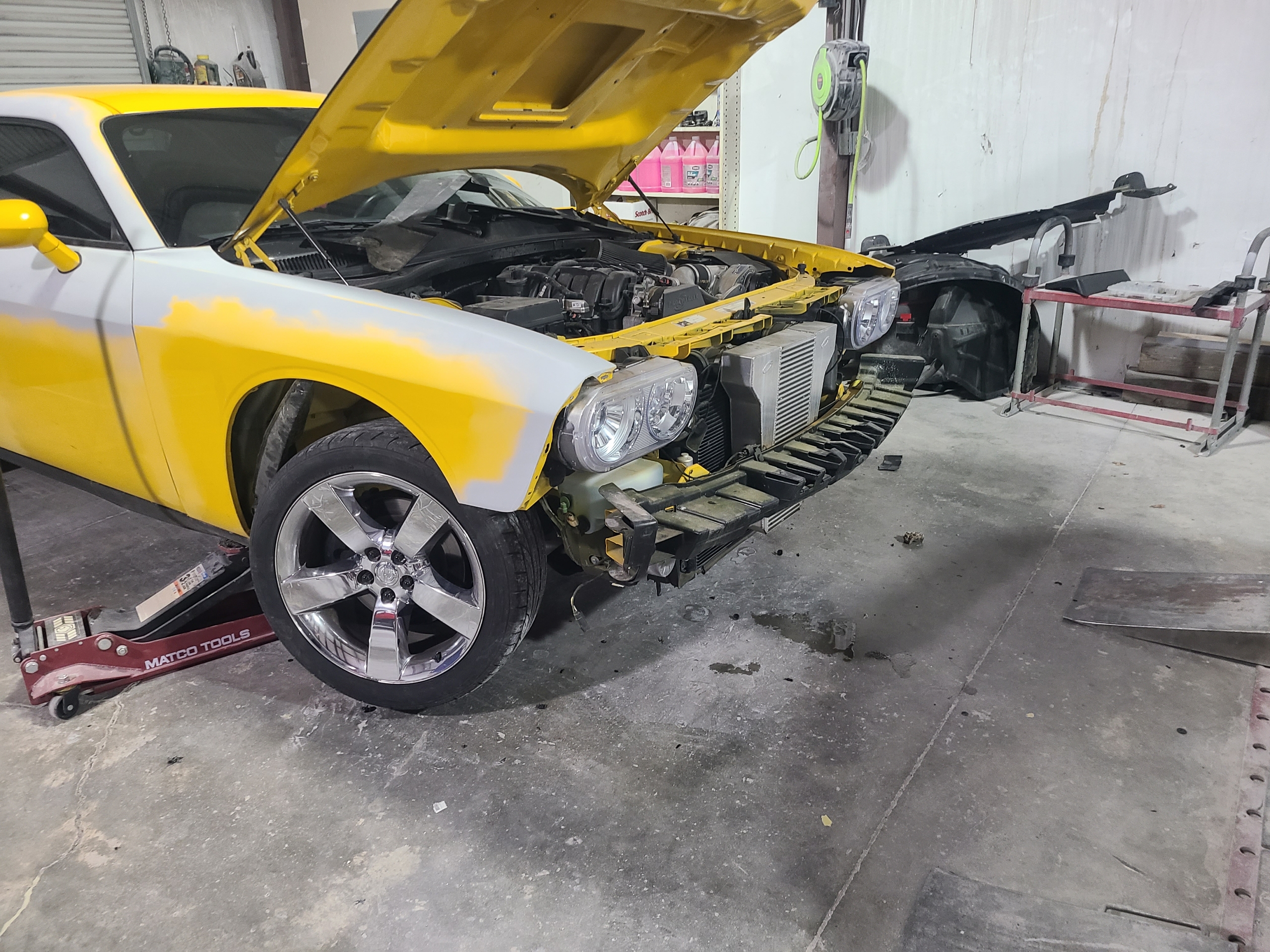 Engine bay detail on a yellow Camaro build