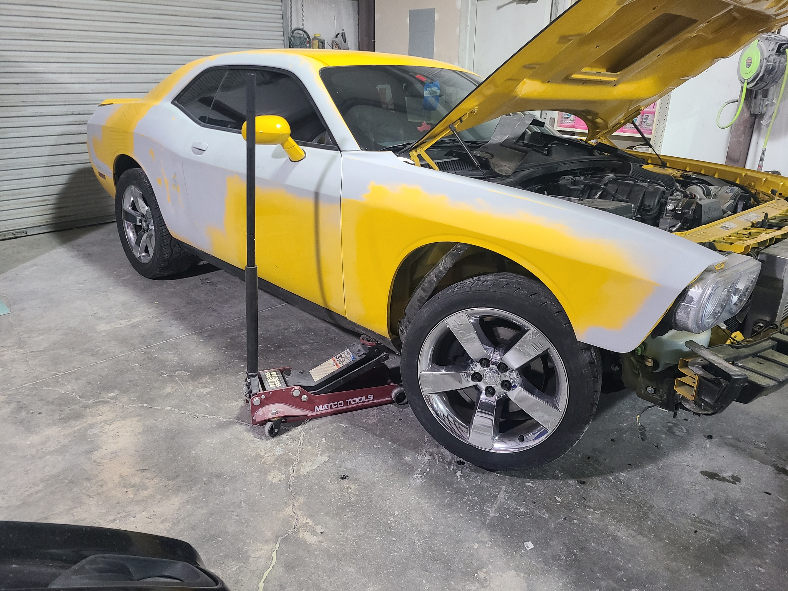 Yellow Dodge Challenger during body work